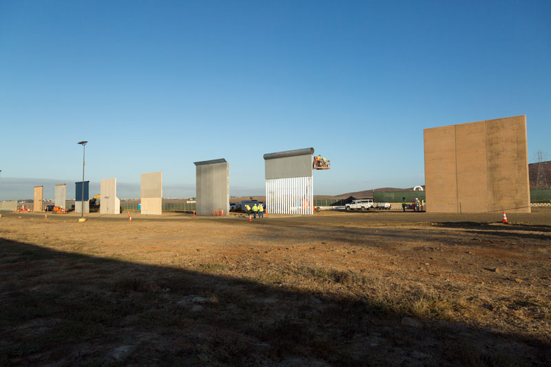 A view of eight sections of prototype walls each at least 18 feet tall.